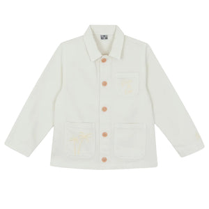 The Girls' Ermana Jacket by Bonton is a white, cotton workwear-style button-up with long sleeves, three front pockets, and subtle palm tree embroidery on two of the pockets.