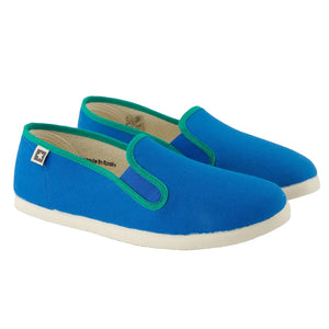 A pair of Bonton Boys' and Girls' John Slippers in blue canvas with green trim and white rubber soles, shown side by side.