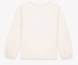 The Girls’ Mermaid Patch T-Shirt by Bonton is pictured from the back, showcasing long sleeves with elastic cuffs and a classic round neckline in an off-white color against a white background.
