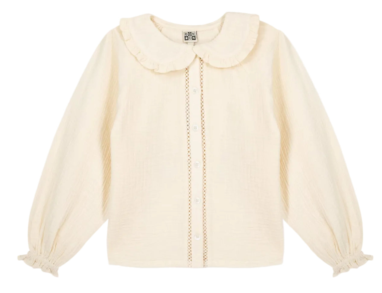 The Girls’ Figue Shirt by Bonton features a cream long-sleeve design with a ruffled Peter Pan collar, button-down front, pleated texture, and lace trim detail.