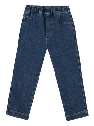 The Boys’ Fracas Pant by Bonton features a straight-leg cut in blue denim, designed with an elastic waist for added comfort, front pockets, and a classic five-pocket style, shown laid flat on a white background.
