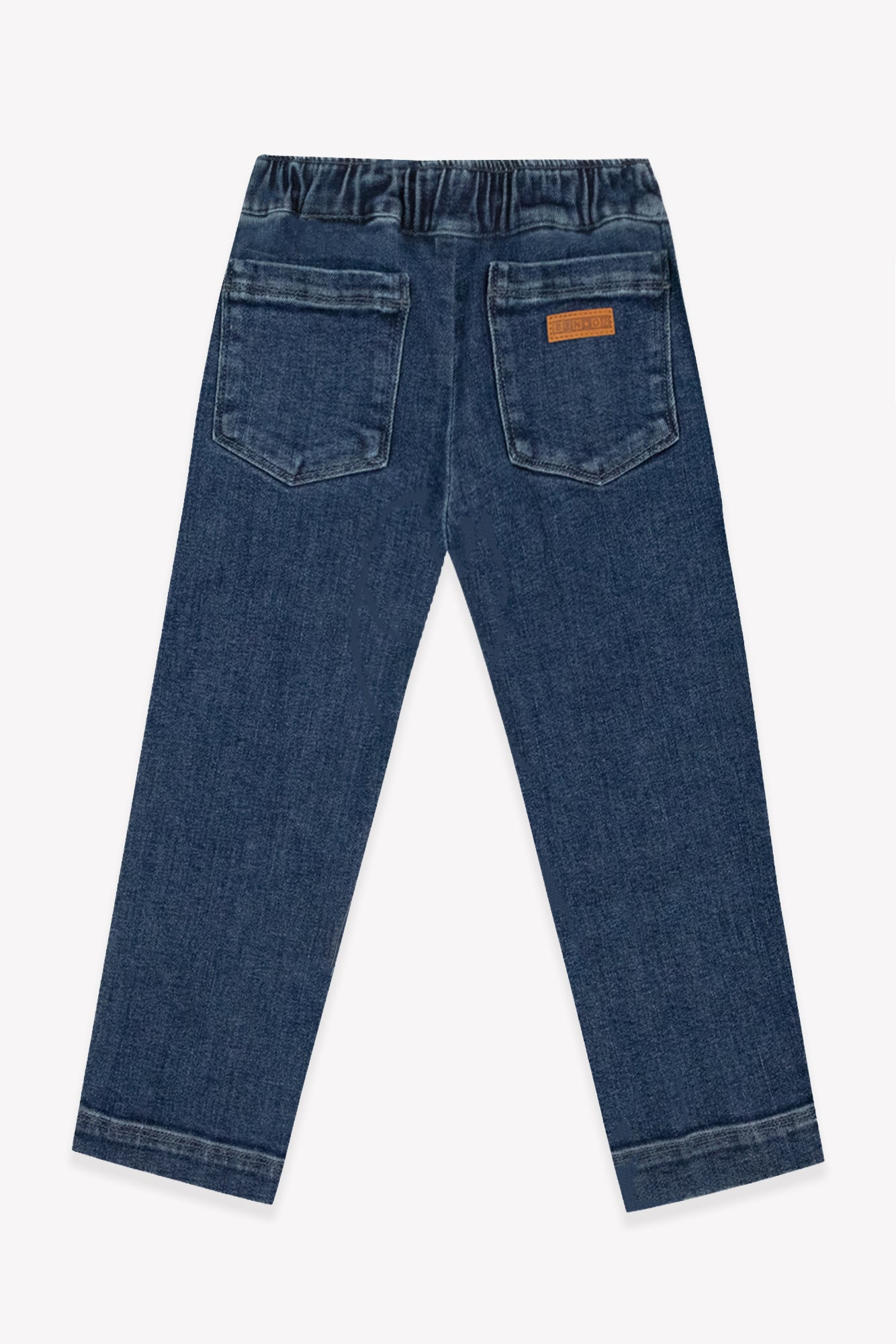 Back view of the Boys’ Fracas Pant by Bonton in mid-wash blue denim, featuring a comfortable elastic waist, two back pockets, and a small tan Bonton brand label for a casual look.