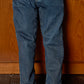 Bonton Boys’ Fracas Pant in mid-blue features straight legs, visible seam detailing, and an elastic waist for a comfortable, casual style. Shown paired with tan ankle boots and a fair isle knit sweater.