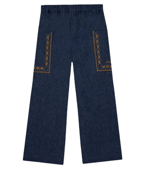 The Girls’ Lauren Pant by Bonton features wide-leg chambray cotton, an elastic waistband, and geometric brown embroidery on both back pockets. Displayed flat on a white background, these stylish girls’ pants offer a chic and comfortable option for any wardrobe.
