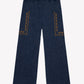The Girls’ Lauren Pant by Bonton features dark blue, wide-leg trousers crafted from soft chambray cotton with an elastic waistband and two large front pockets detailed in a brown geometric pattern—offering both comfort and style.
