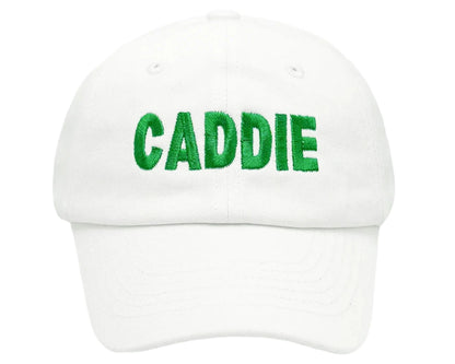 The Bits & Bows Caddie Baseball Hat is a white cap with "CADDIE" in green embroidery—ideal sun protection for boys on and off the course.