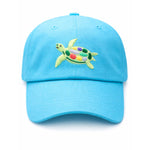 The Bits & Bows Turtle Hat is a bright blue baseball cap featuring an embroidered sea turtle with a multicolored shell, displayed against a plain white background.