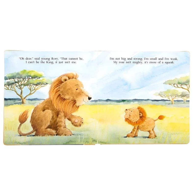 The Jellycat "The Very Brave Lion Book" features an illustration of a large lion and small cub in a grassy savanna, with text above each that captures the cub's doubts about being king and his quiet roar, reflecting the book’s poetic charm.