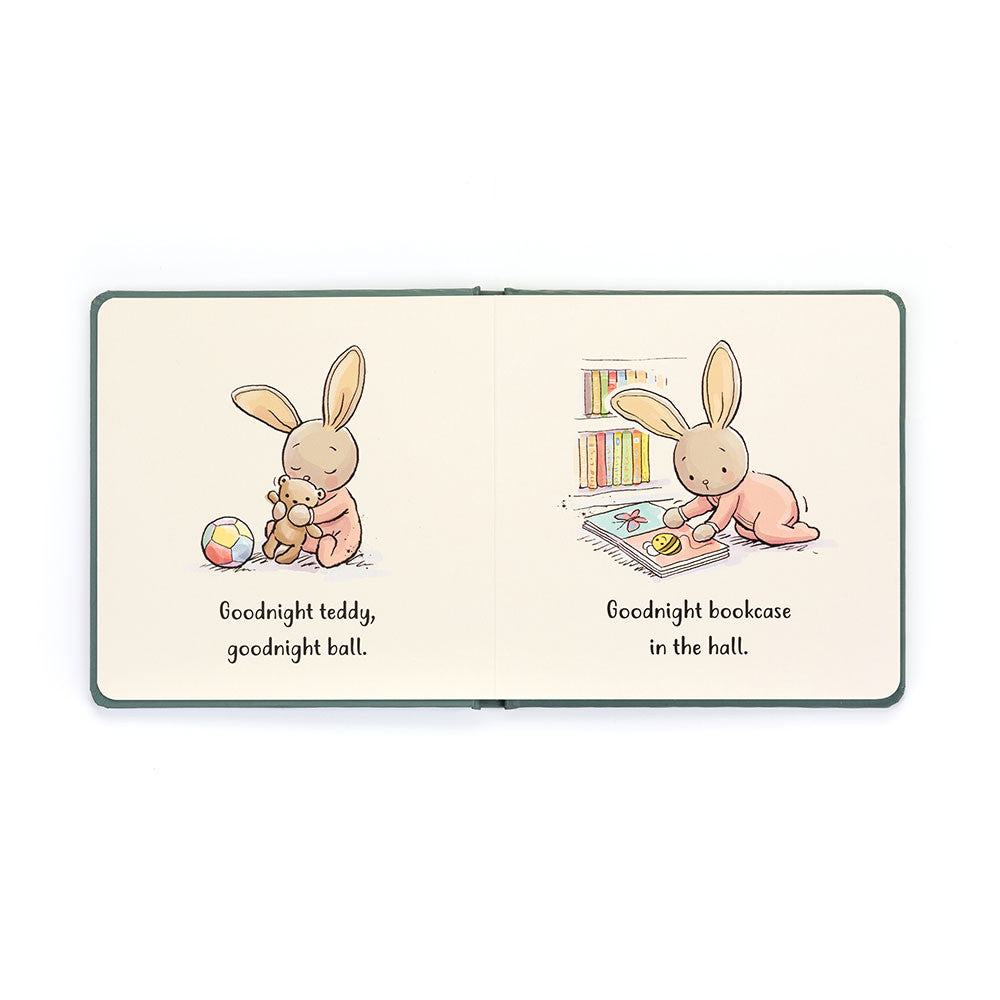 An open children's book with illustrations of a bunny; on the left, holding a teddy and a ball, and on the right, sitting by a bookcase. The text reads "Goodnight Teddy, goodnight ball. Goodnight bookcase in the hall." An enchanting bedtime story titled "Jellycat Goodnight Bunny Book" by Jellycat.