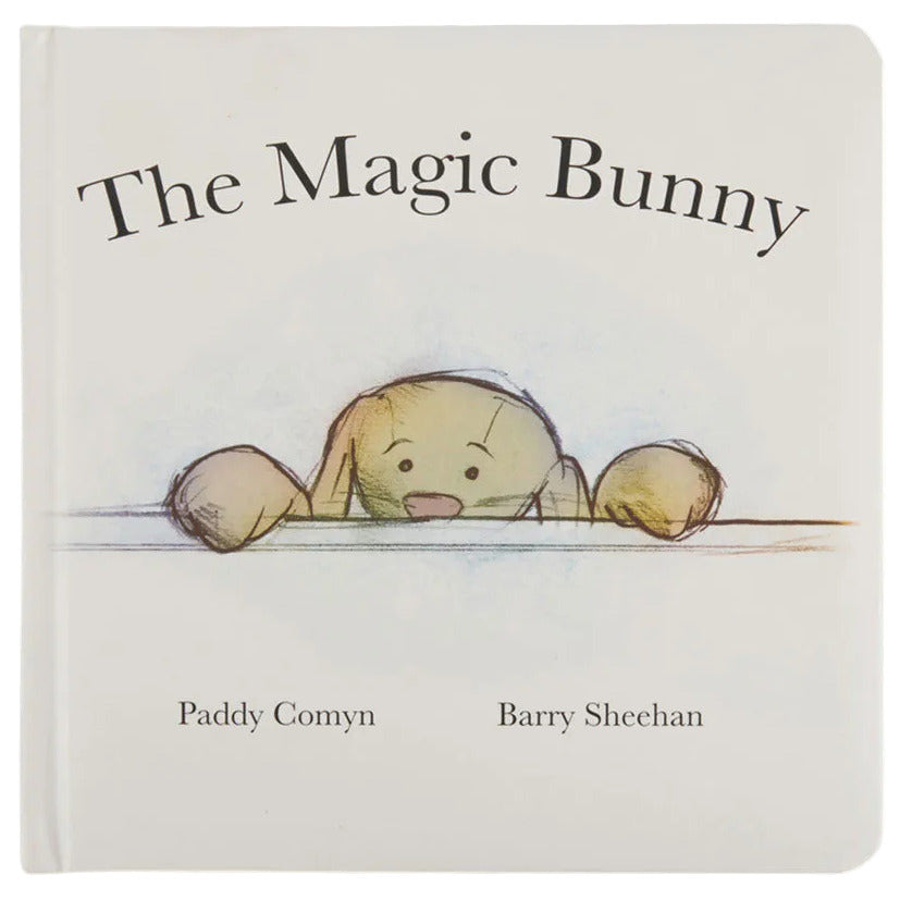The Magic Bunny Book by Jellycat is a charming white children’s book featuring an illustrated bunny peeking over a surface—perfect for bedtime stories.