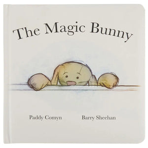 The Magic Bunny Book by Jellycat is a charming white children’s book featuring an illustrated bunny peeking over a surface—perfect for bedtime stories.