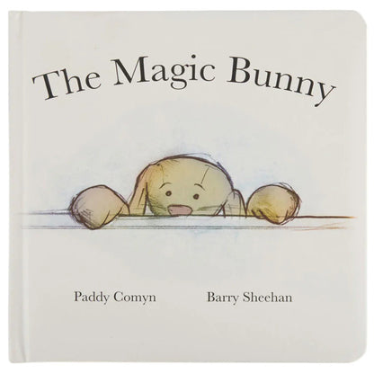 The Magic Bunny Book by Jellycat is a charming white children’s book featuring an illustrated bunny peeking over a surface—perfect for bedtime stories.
