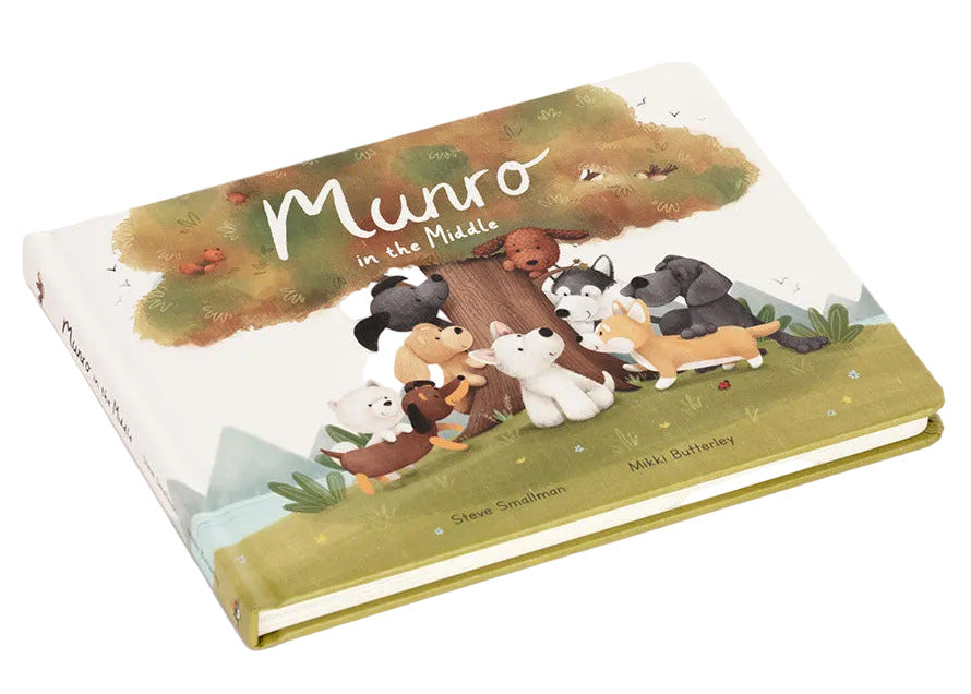 The Jellycat "Munro in the Middle Book" is a children's book with illustrated animals and playful pups gathered around a tree on its cover.