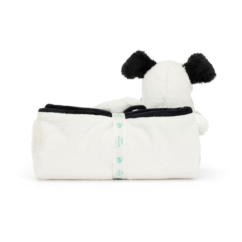 A rolled-up white and black plush panda bear blanket with small green tags, seen from the side, features soft fur akin to the Jellycat Bashful Black & Cream Puppy Blankie by Jellycat.