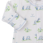 A close-up of the Kissy Kissy Fairway Foursome Printed Convertible Gown, a white Pima cotton baby onesie featuring golf-themed illustrations such as golf carts, clubs, and flags.