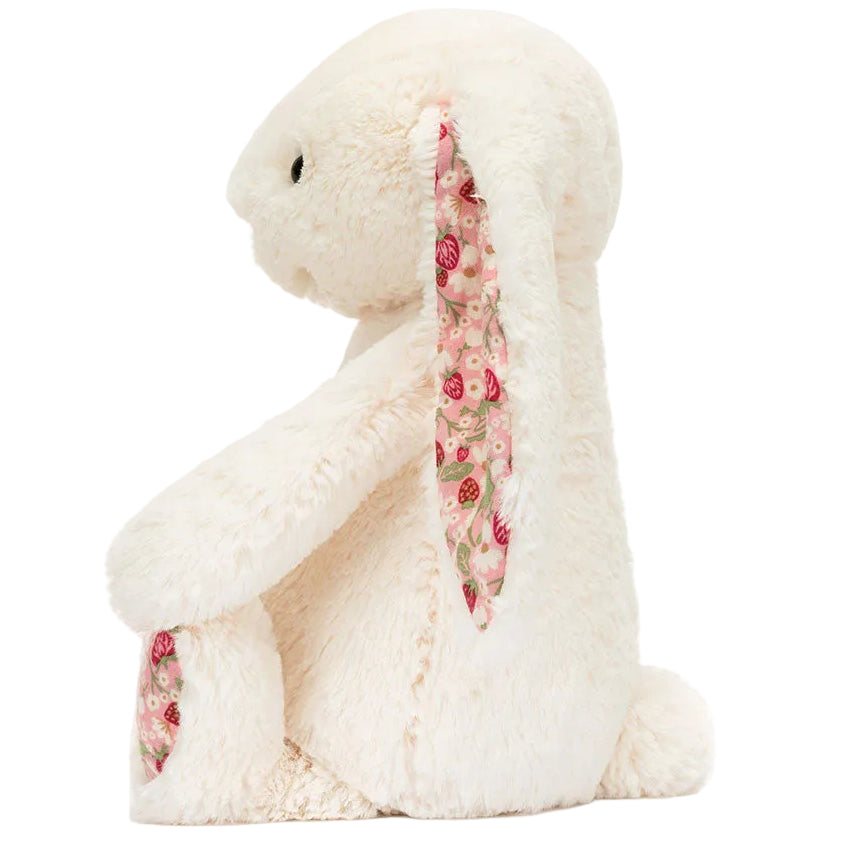 Blossom Cream Bunny ‘Berry’ by Jellycat sits upright on a plain background, featuring charming floral fabric on the inside of its ears and feet—a delightful plush bunny stuffed animal perfect for cuddling or display.