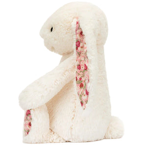 Blossom Cream Bunny ‘Berry’ by Jellycat sits upright on a plain background, featuring charming floral fabric on the inside of its ears and feet—a delightful plush bunny stuffed animal perfect for cuddling or display.