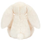 A plush Jellycat Blossom Cream Bunny ‘Berry’ is shown from the back, featuring long floppy ears and a small round tail, reminiscent of the brand’s classic bunny stuffed animals.