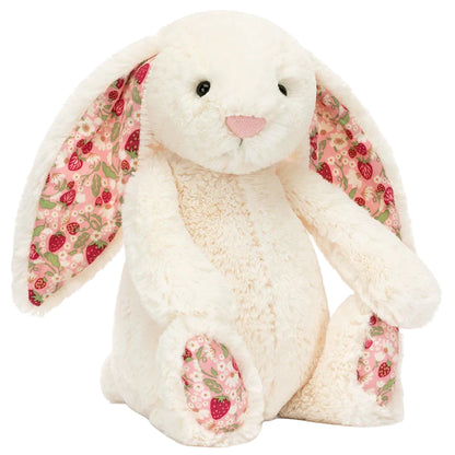 Blossom Cream Bunny ‘Berry’ by Jellycat sits upright against a white background, showcasing its plush white fur, long ears lined with pink floral fabric on the inner ears and feet—an adorable stuffed animal perfect for snuggles.