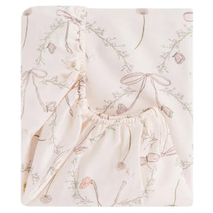 The Bows & Butterfly Kisses Crib Sheet by Gooselings features an OEKO-TEX certified design with cream-colored cotton sateen, adorned with floral and bow patterns and gathered elastic edges for your baby's safety and comfort.
