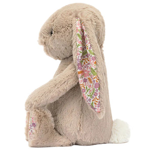 Blossom Beige Bunny 'Petal' by Jellycat sits upright in profile, with wildflower-print inner ears and paws plus a white fluffy tail—an adorable member of the Jellycat Garden Club bunny plush collection.