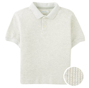 The Boys' Keith Waffle Knit Polo Shirt by Gingersnaps features a light grey, waffle-knit texture, short sleeves, collar, and two buttons—stylish and comfortable for boys, with close-up detail highlighting its unique fabric.
