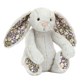 Introducing the Jellycat Blossom Silver Bunny 'Bloom' Small, a plush grey companion with Jellycat's signature Bashful fur. This delightful creation sits upright, showcasing exquisite floral-patterned inner ears and feet, making it an enchanting addition to any collection.