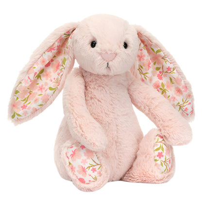 A light pink Jellycat Blossom Blush Bunny ‘Cherry’ plush with long ears and floral-patterned fabric, sitting upright on a white background.
