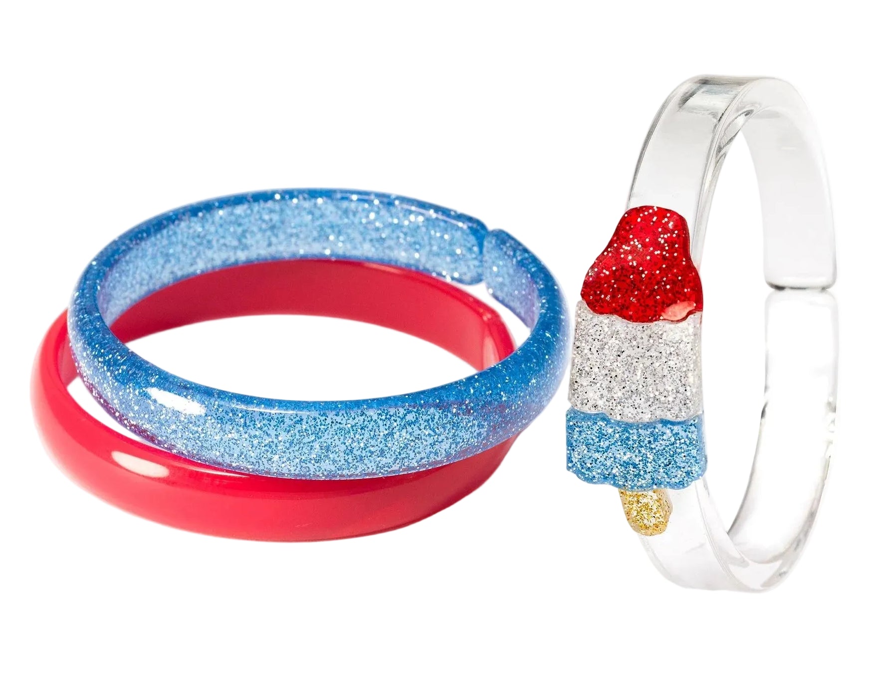 The Lillies & Roses Popsicle Rocket Glitter Red Blue Bangles set includes two glittery red and blue bracelets and a clear bangle with a red, white, and blue popsicle charm—perfect patriotic jewelry for any outfit.