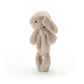 A soft, beige Jellycat Bashful Beige Bunny Ring Rattle stands upright with its long ears hanging down by its sides against a plain white background, delighting any baby who sees it.