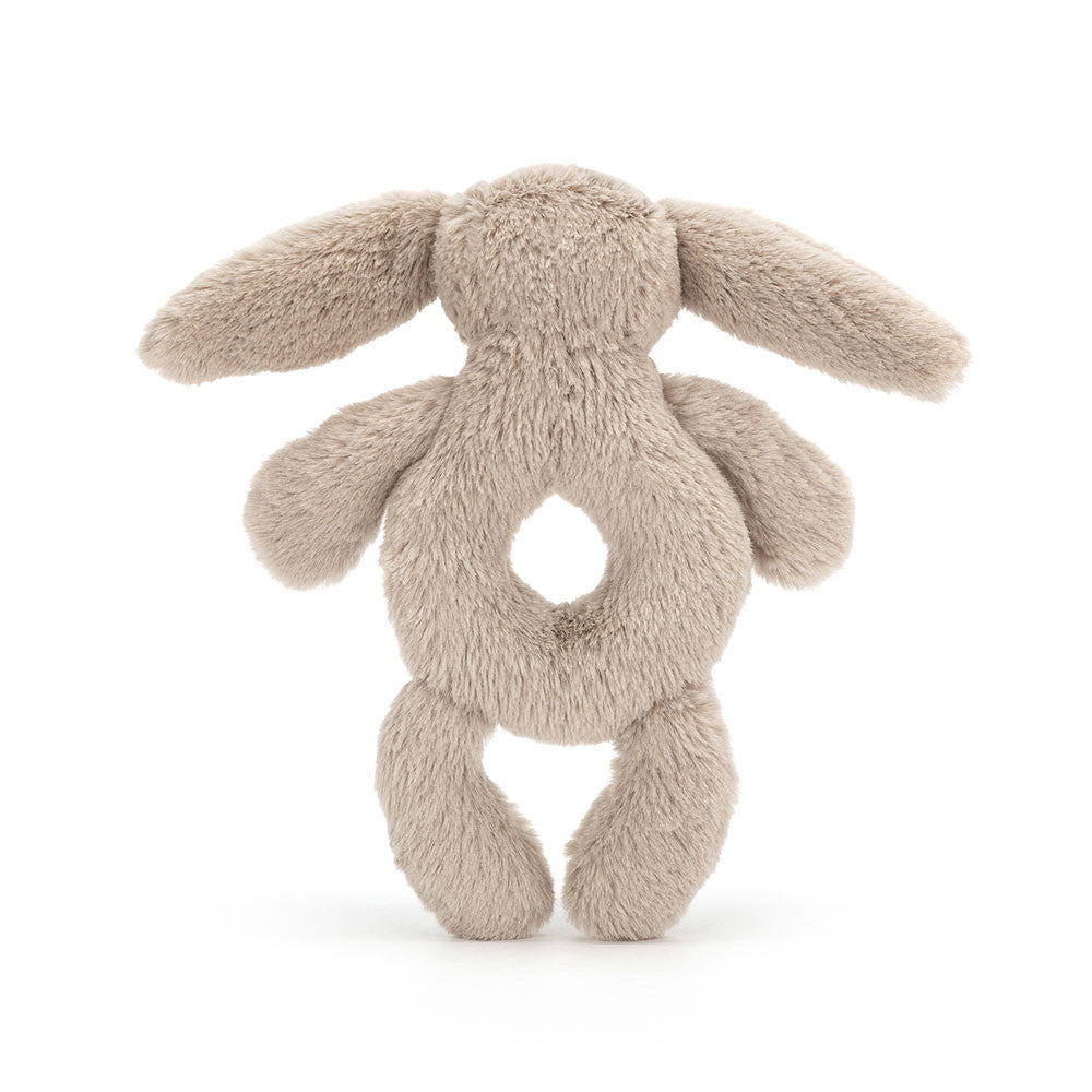 Jellycat Bashful Beige Bunny Ring Rattle plush stuffed toy with long ears and a circular ring rattle in the middle, shown from the back, on a white background.