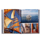 The open photo book "Boatlife: Exploring the Freedom of Maritime Living" by Graphic Image displays images of a tall ship at sea, its sails, rigging, crew on deck, and a dog—reflecting maritime adventure and nomadic living.