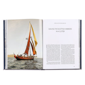 Open to a photo of a red-sailed cutter on the ocean beside "Sailing the Scottish Hebrides in a Cutter," Boatlife: Exploring the Freedom of Maritime Living by Graphic Image inspires dreams of maritime adventure and nomadic living.