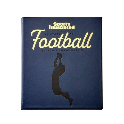 The blue cover of Graphic Image's "The Story of Football Leather Book" showcases a silhouette of a jumping football player, reflecting the spirit of gridiron glory from exhilarating games to legendary Super Bowls.