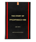 The Story Of Porsche Black Leather Book by Graphic Image exudes luxury with its black cover, accentuated by red and gold vertical stripes, capturing the essence of race car manufacturing.