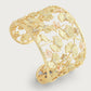 The Anabel Aram Butterfly Cuff Bracelet features an intricate floral and leaf design with textured details, small pink accents, and crystal jewelry for a shimmering touch.