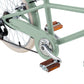 Close-up of a light green Banwood Kids’ Vintage Classic Bike frame, highlighting the pedal, chain guard, gear system, and beige-spoked tires—a stylish children’s seven-speed bicycle that adds vintage charm to young riders’ cycling adventures.