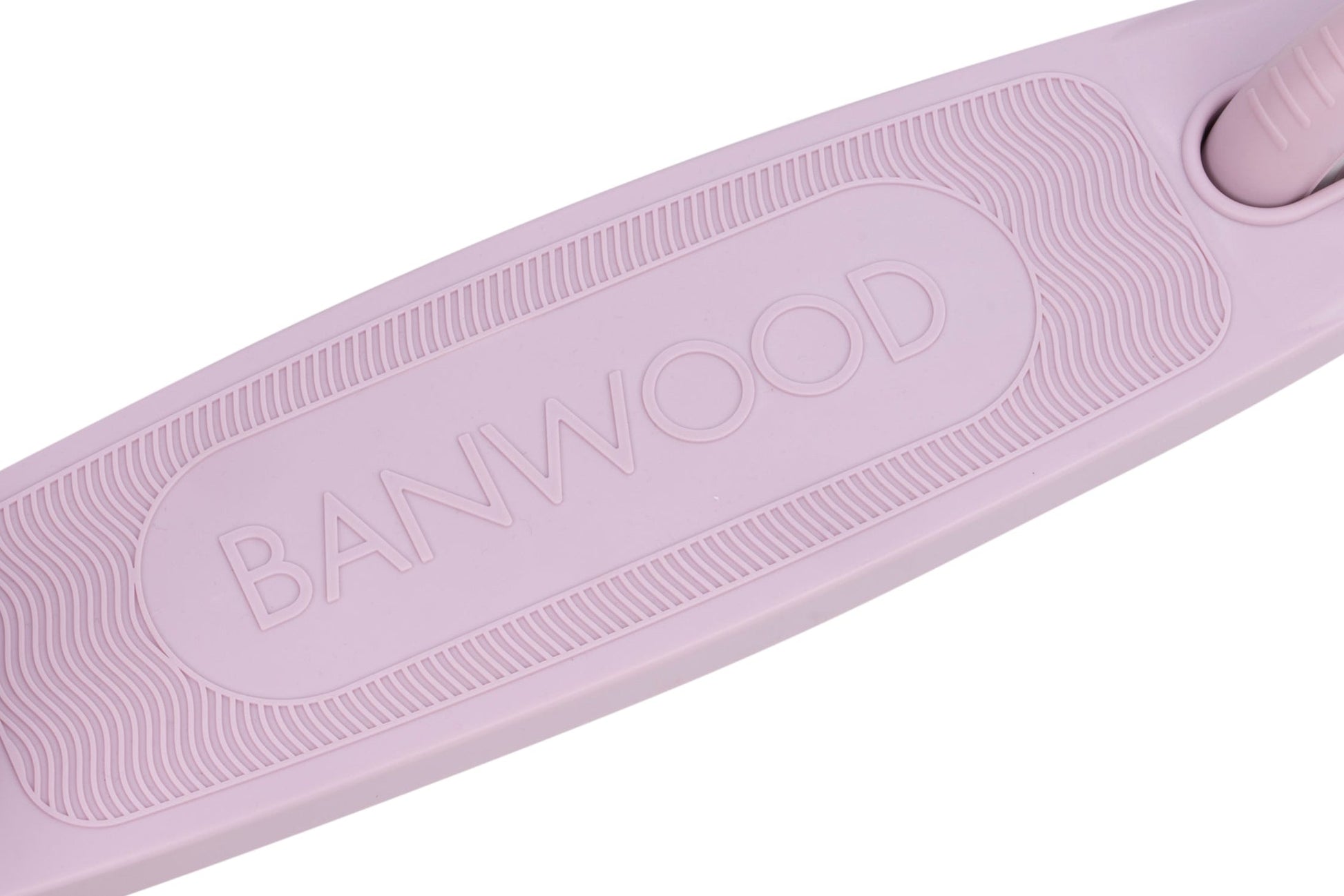 Close-up of a textured, pale pink surface featuring the embossed word “BANWOOD” in the center, reflecting Banwood’s dedication to quality and design—an ideal detail for their Kids’ Eco Scooter with Basket.