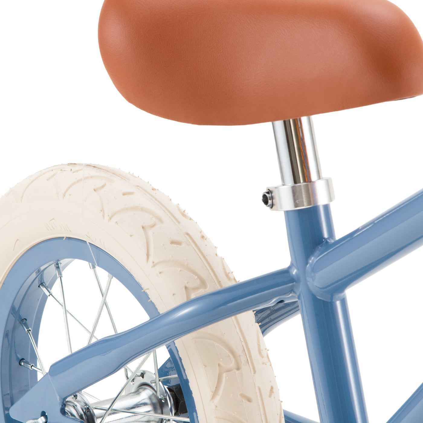 Close-up of the blue Kids’ Vintage First Go Balance Bike by Banwood, featuring a brown seat, chrome seat post, white rear tire, and spokes against a white background.