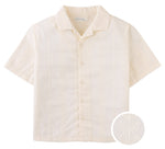 The Boys' Armin Embroidered Camp Collar Shirt by Gingersnaps features short sleeves, an off-white hue, subtle leaf embroidery, a notched camp collar, and includes a circular inset showing the fabric detail.
