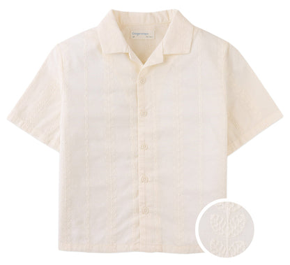 The Boys' Armin Embroidered Camp Collar Shirt by Gingersnaps features short sleeves, an off-white hue, subtle leaf embroidery, a notched camp collar, and includes a circular inset showing the fabric detail.