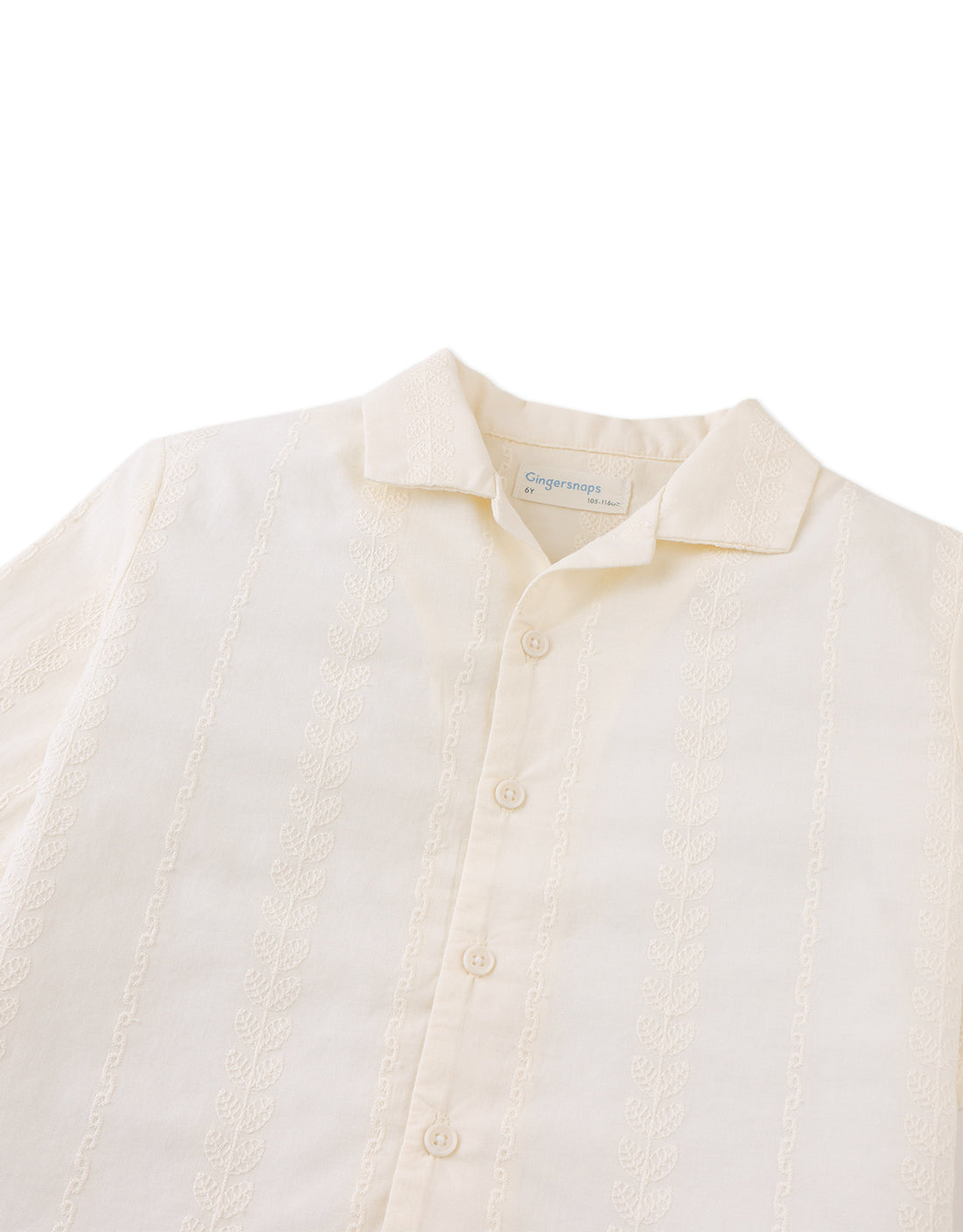 The Boys' Armin Embroidered Camp Collar Shirt by Gingersnaps is an off-white kids' shirt with short sleeves, textured vertical patterns, and subtle leaf embroidery.