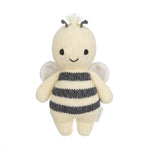 The Cuddle + Kind Bee - Baby 7" is a handcrafted, knitted plush toy featuring black and white stripes, small wings, a smiling face, and short antennae—an heirloom-quality addition to any hand-knit baby animals collection.