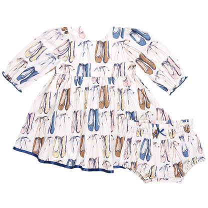 The Pink Chicken Baby Girls' Amma Dress by Pink Chicken is a charming white cotton poplin baby dress that comes with a matching bloomer, both beautifully adorned with ballet slippers in an array of colors. This lovely outfit is perfect for your little dancer!