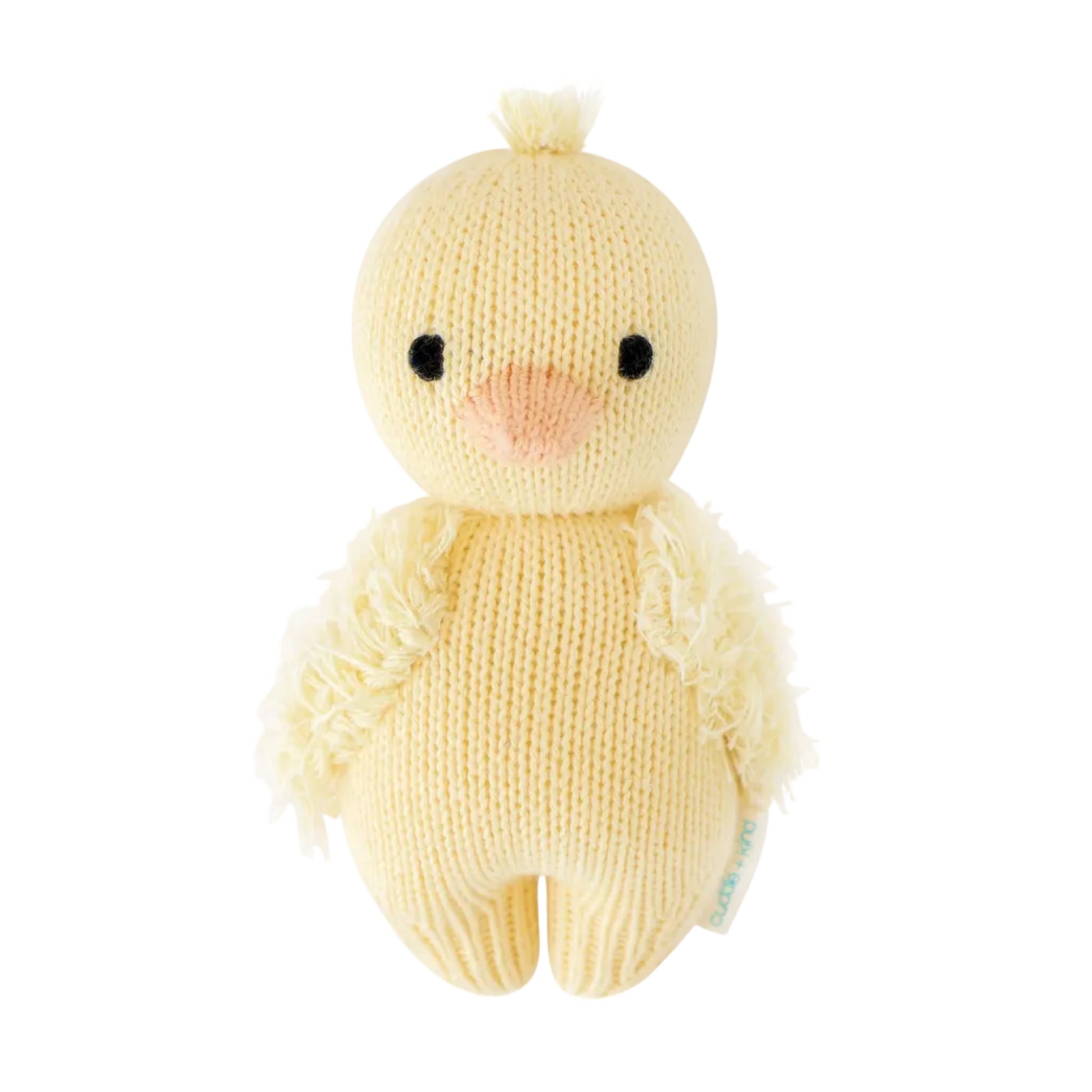 The Baby Duckling by Cuddle + Kind is a handcrafted plush chick toy, made from Peruvian cotton yarn and featuring black eyes, a peach beak, and textured wings in a cheerful yellow hue. Inspired by classic heirloom baby animals, it is displayed against a white background.