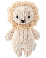 The Baby Lion by Cuddle + Kind is an heirloom-quality, hand-knit toy featuring a beige body, fluffy mane, and black eyes and nose, pictured on a white background.