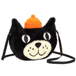 Introducing the Jellycat Bag by Jellycat: a black plush accessory designed like a cat's face, featuring large eyes, a smiling mouth, and an orange hat on its head. The bag boasts liquorice fur and has a webbed cross-body strap for easy carrying.