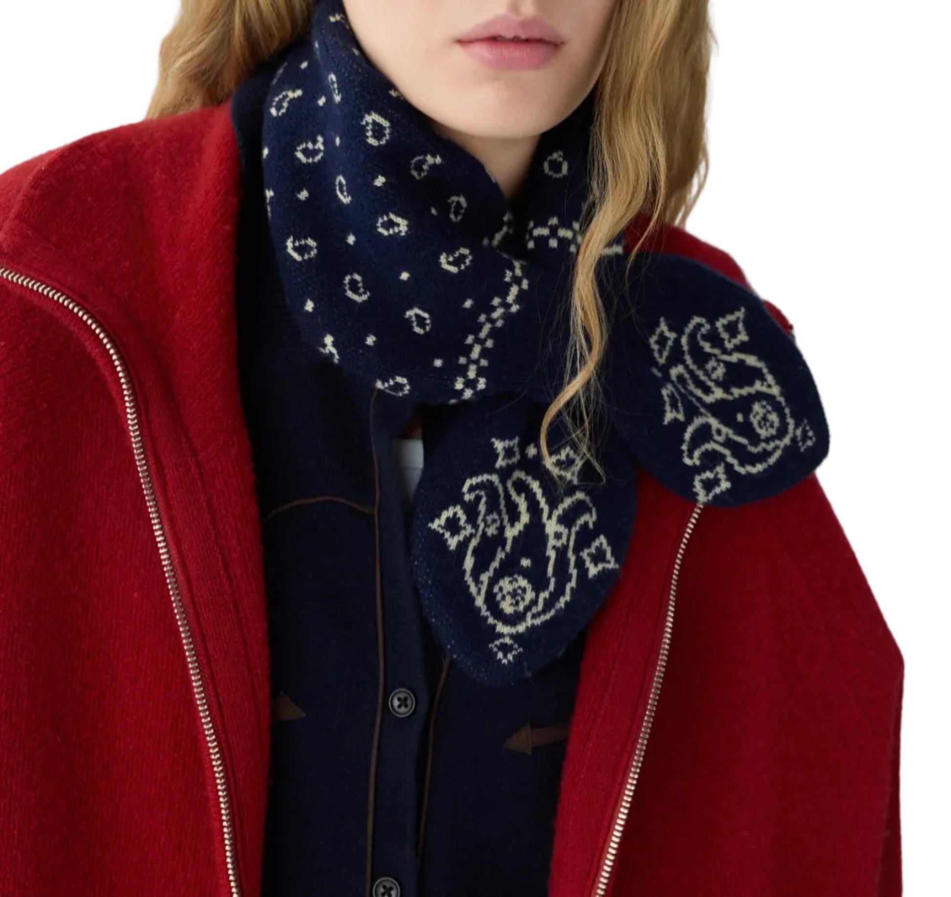 A person wearing a red coat, navy blue shirt, and the Bandana Bowtie Scarf with white designs from Guest in Residence.