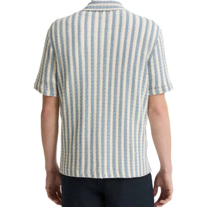 A person shown from the back wears the vince Playa Stripe Shortsleeve Shirt, featuring airy Italian cotton-blend fabric and vertical blue and white seaside-inspired stripes.