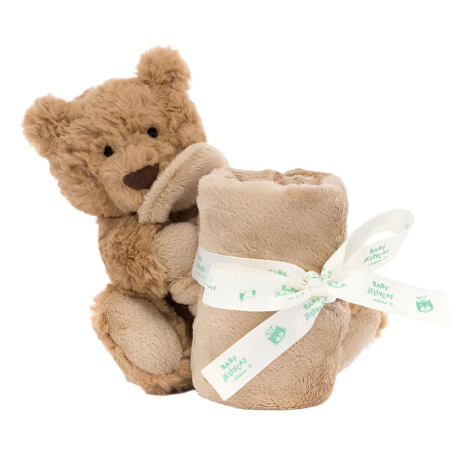 Introducing the adorable Baby Jellycat, showcasing a plush teddy bear crafted from recycled fabrics and holding the Jellycat Bartholomew Bear Soother—a cozy rolled blanket tied with a ribbon, perfect for comforting little ones.